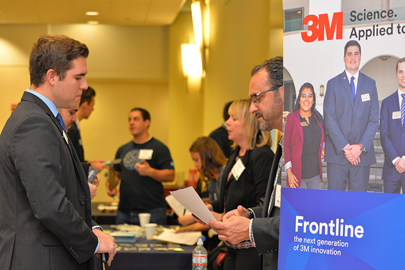 Student and employer interacting at Sales Leadership Career Fair